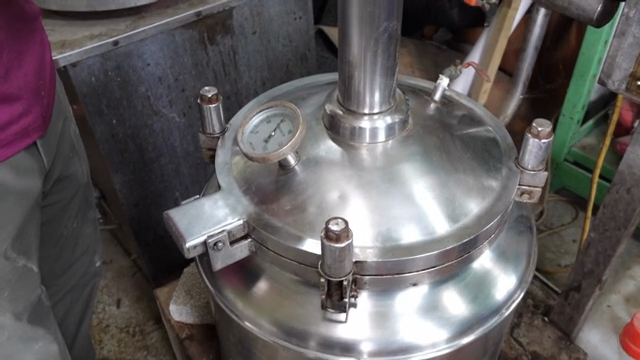 A large metal container in a workshop