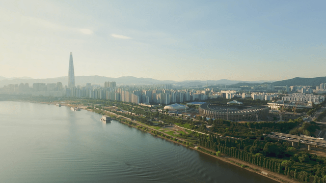 A cityscape with a river and stadium