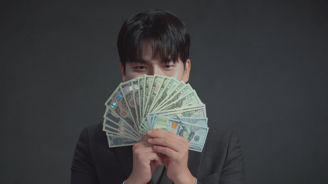 Man holding US dollar bills with a smile