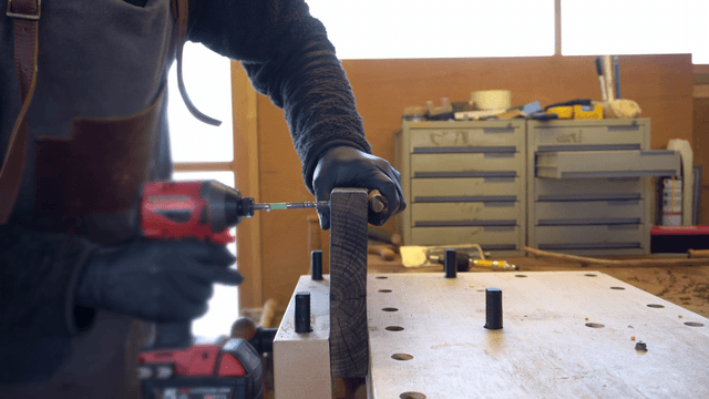 Person using a drill in a workshop