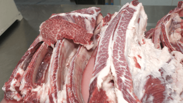 Marbled Korean beef ribs on the cutting board after butchering