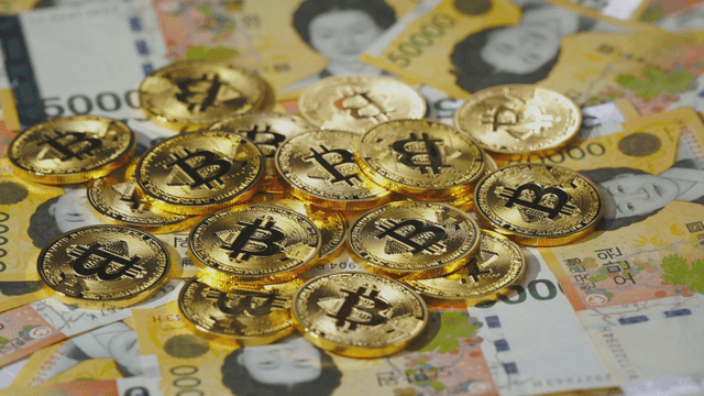 Bitcoin coins on Korean won bills
