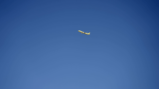 Yellow airplane flying in the clear sky