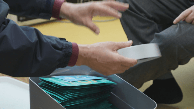 Person holding a clock in house