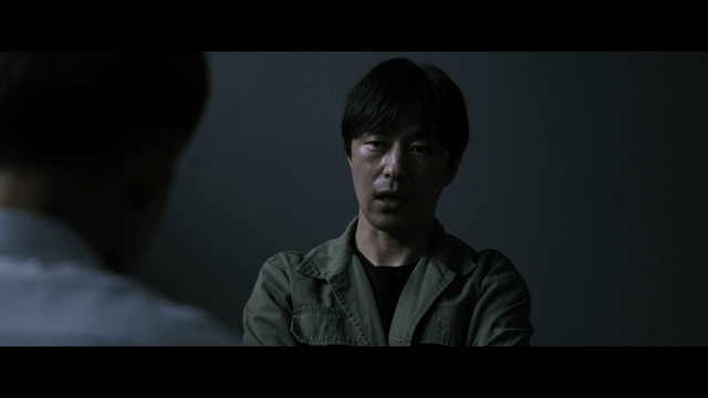 Man interrogating in dark room