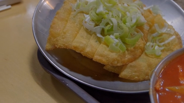 Crispy dumplings topped with fresh leeks