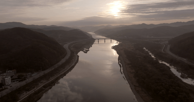 A river winding through mountains at dusk
