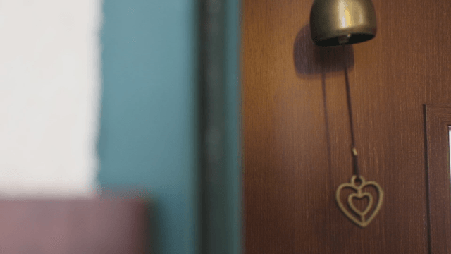 A heart-shaped bell hanging on a door
