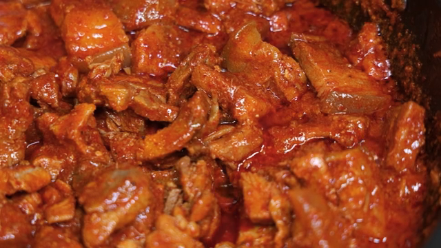 Spicy stir-fried pork simmering in a pot