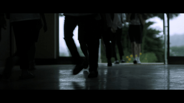 Students going to school through dark hallway