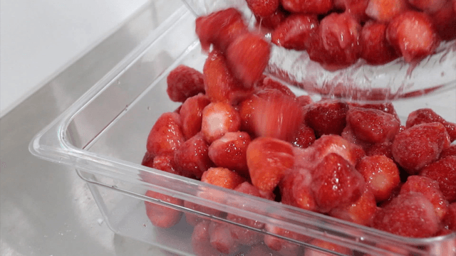 Transferring strawberries mixed with sugar