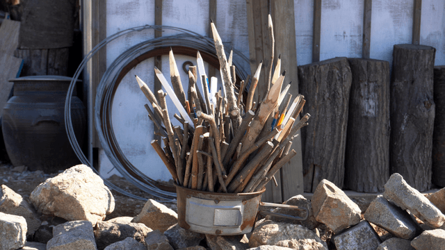 Wooden branch pencil sculpture with warehouse background