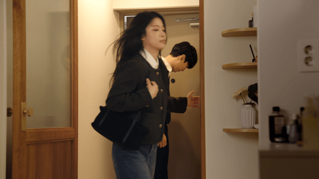 Couple entering home with somber mood