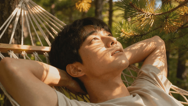 Man resting in a hammock in the forest