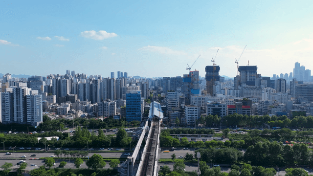 Busy Seoul cityscape with a train passing through the center