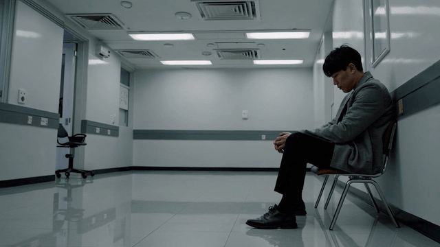 Man sitting in a hallway