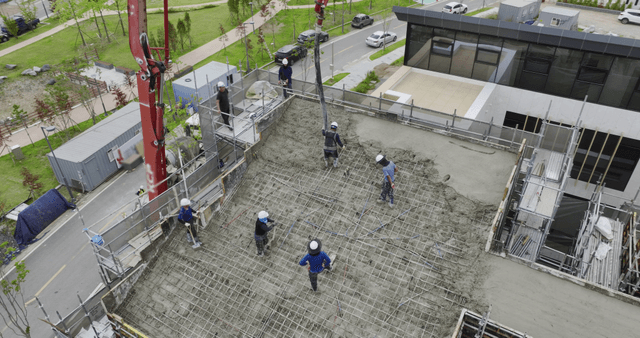 Construction workers pouring concrete
