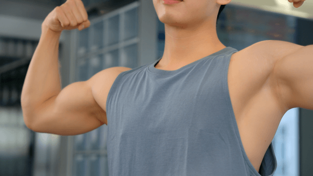 Man flexing muscles indoor