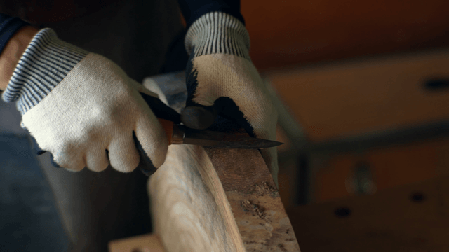 Craftsman carving wood with precision