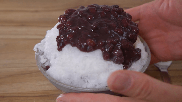 Shaved ice with red beans served on a table