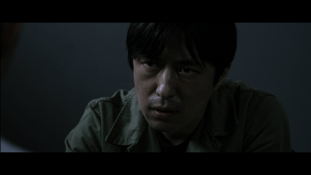Man interrogating in dark room
