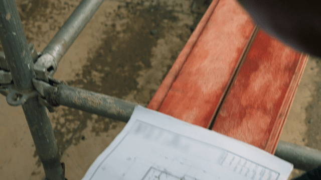 Person reviewing construction blueprints