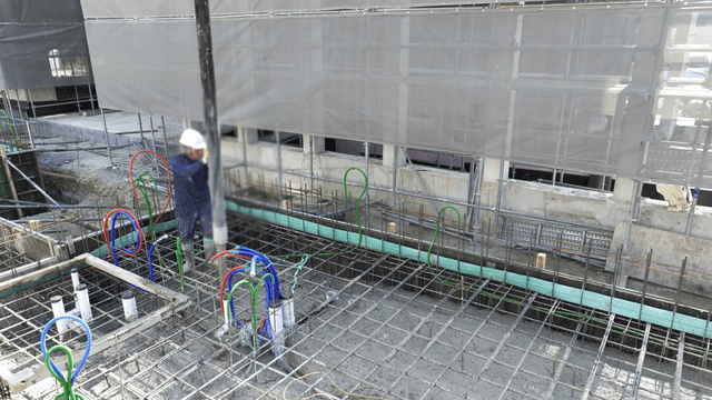 Construction workers pouring concrete