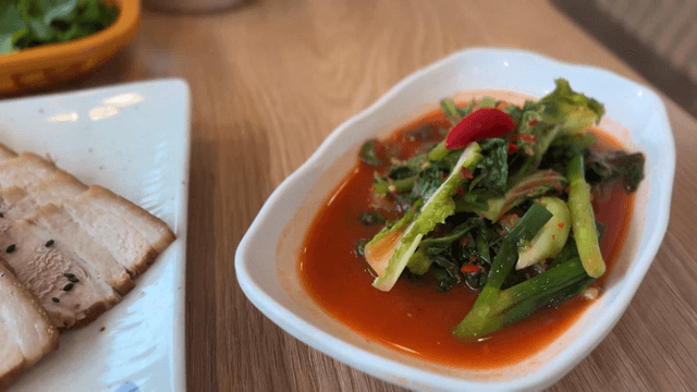napa wraps with pork and young radish kimchi in a neat bowl