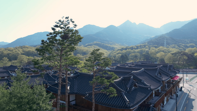 Hanok village with visible mountain ridge in daytime
