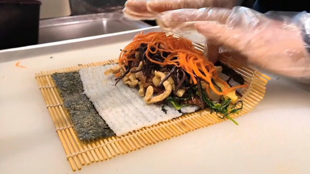 Preparing gimbap with various ingredients