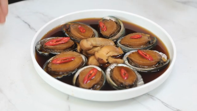 Soy sauce marinated abalone with red chili slices