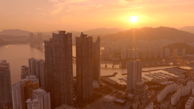 Sunset over a coastal city skyline