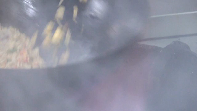 Stir-frying vegetables in a hot wok