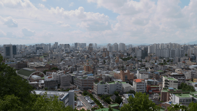 A sprawling cityscape under a cloudy sky