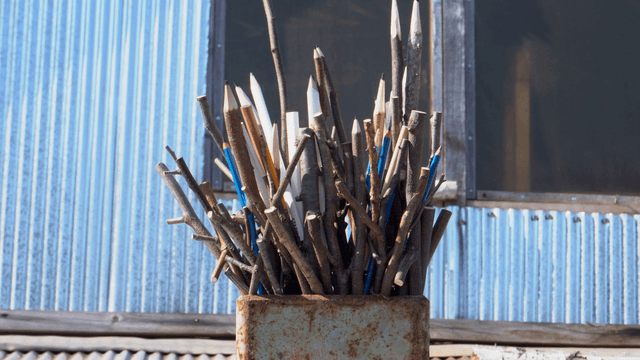 Wooden pencil sculpture placed on a roof