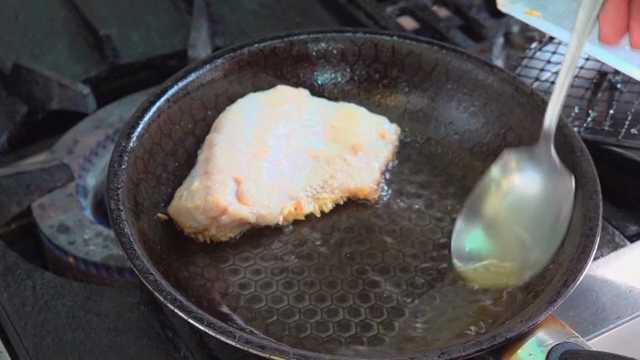 Fish being fried in a pan