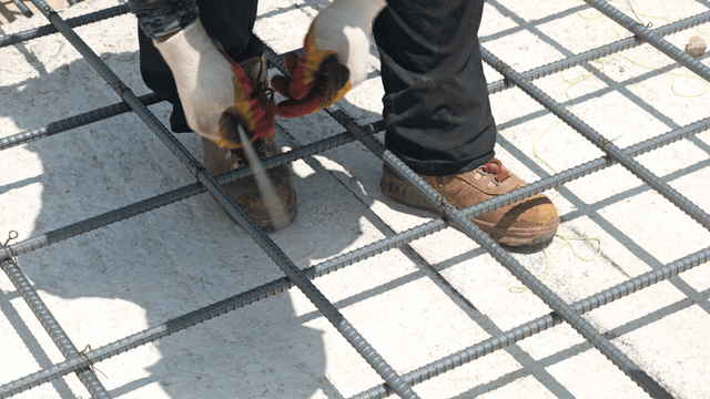 Worker tying rebar on a construction site