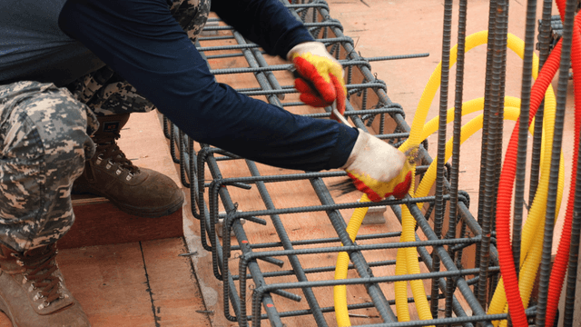 Worker assembling rebar on a construction site