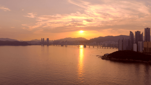 Sunset over a city skyline and bridge