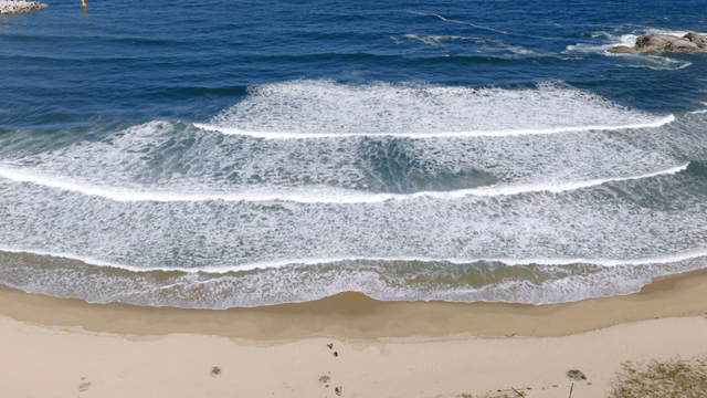 Waves gently crashing on a sandy beach