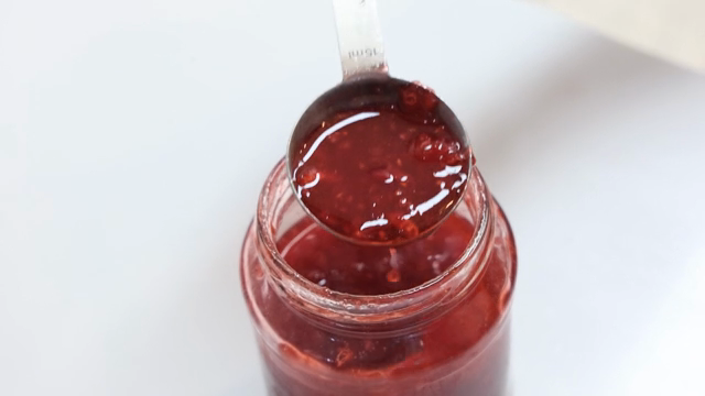 Spoon scooping handmade preserves from a jar