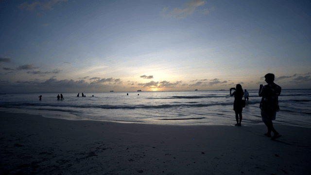 People enjoying a sunset at the beach