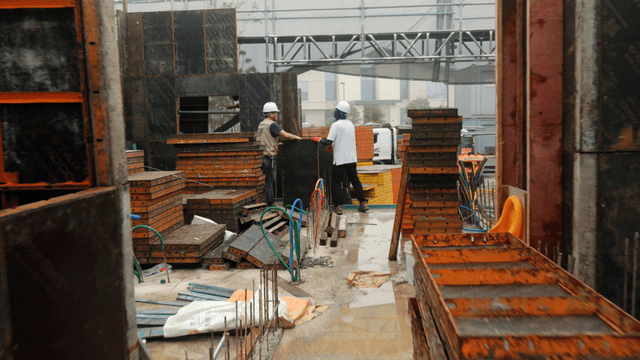 Construction workers assembling panels