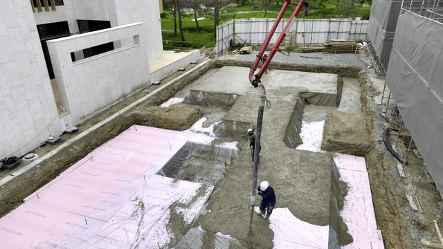Construction workers pouring concrete