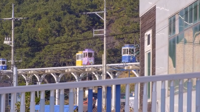 Colorful trams moving on elevated tracks