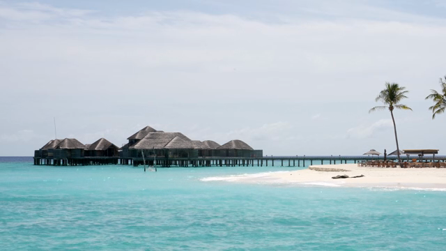 Tropical beach with overwater bungalows