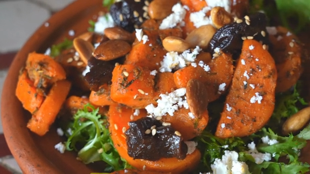 A vibrant salad with nuts and cheese