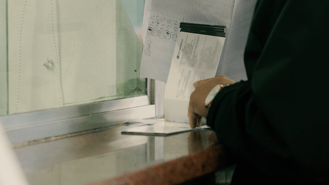 Person handling documents at a counter