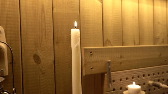 Room with candles and decorations in wooden interior