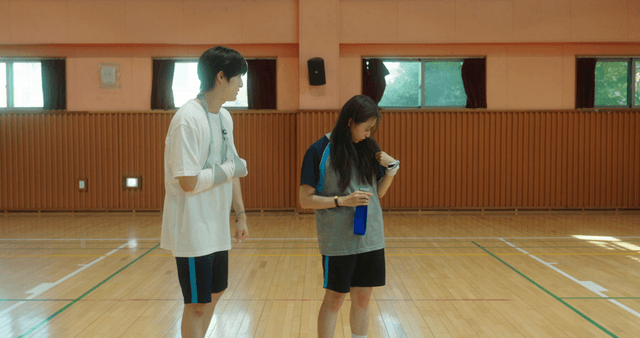 Students in a gym having a conversation